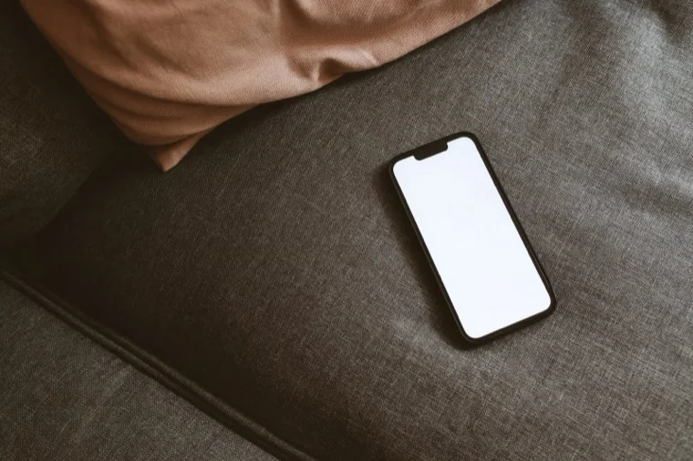 A smartphone resting on a sofa
